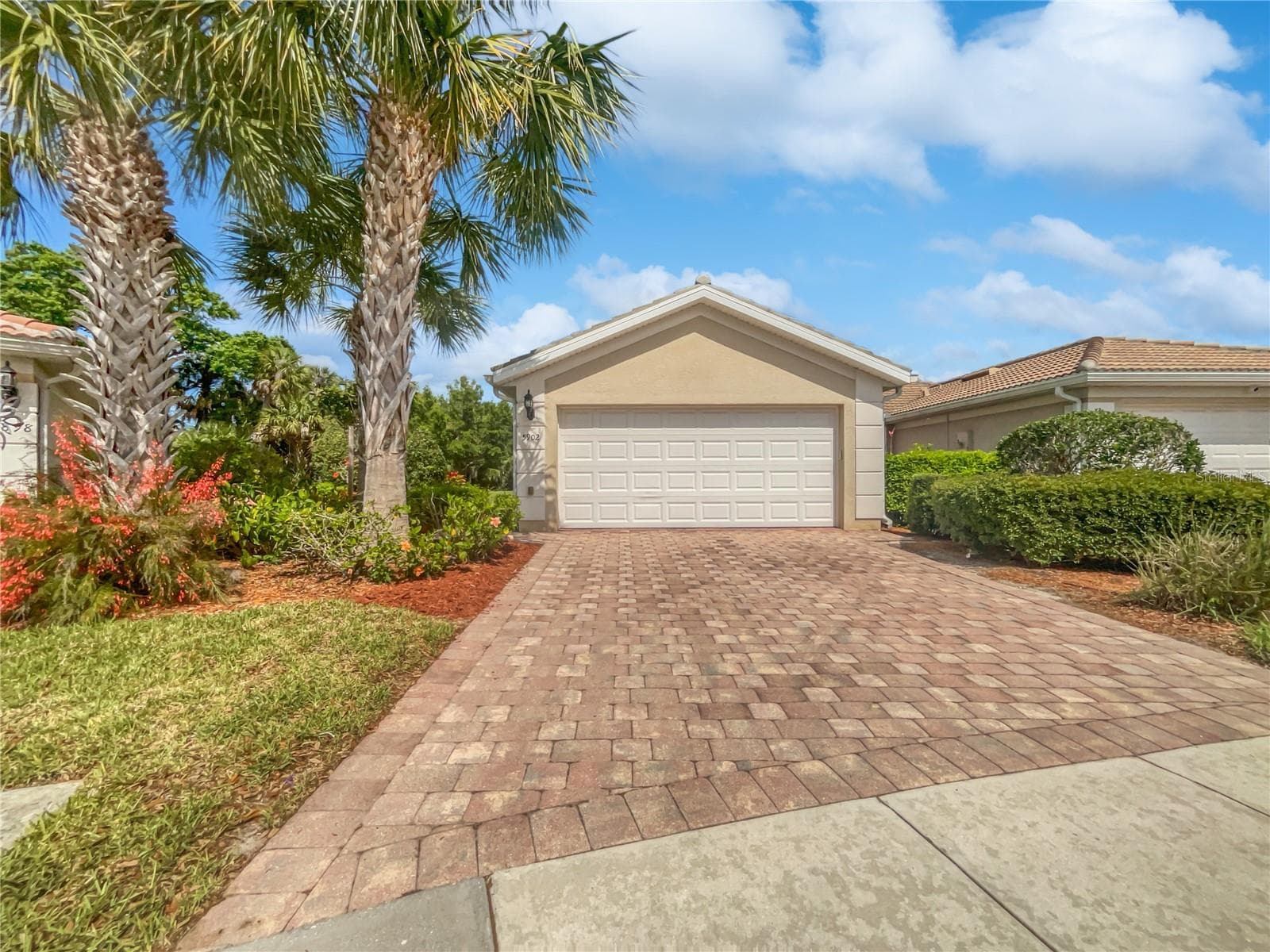 Front exterior of a single-family home with fresh paint in Sarasota Florida