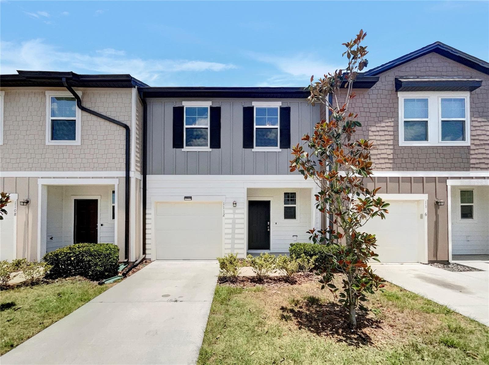 Front exterior of a two-story townhouse built in 2022 in Davenport, Florida.