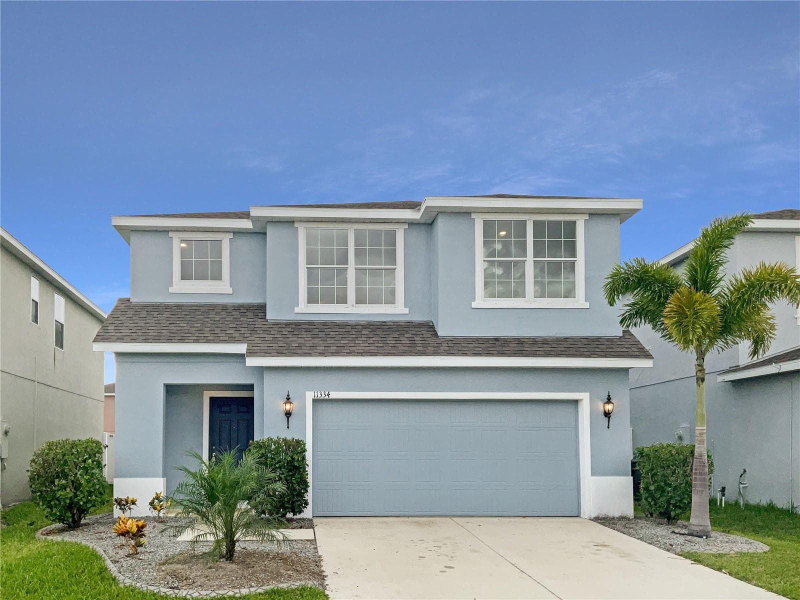 Front exterior of a two-story single-family home with fresh paint in Riverview, FL.