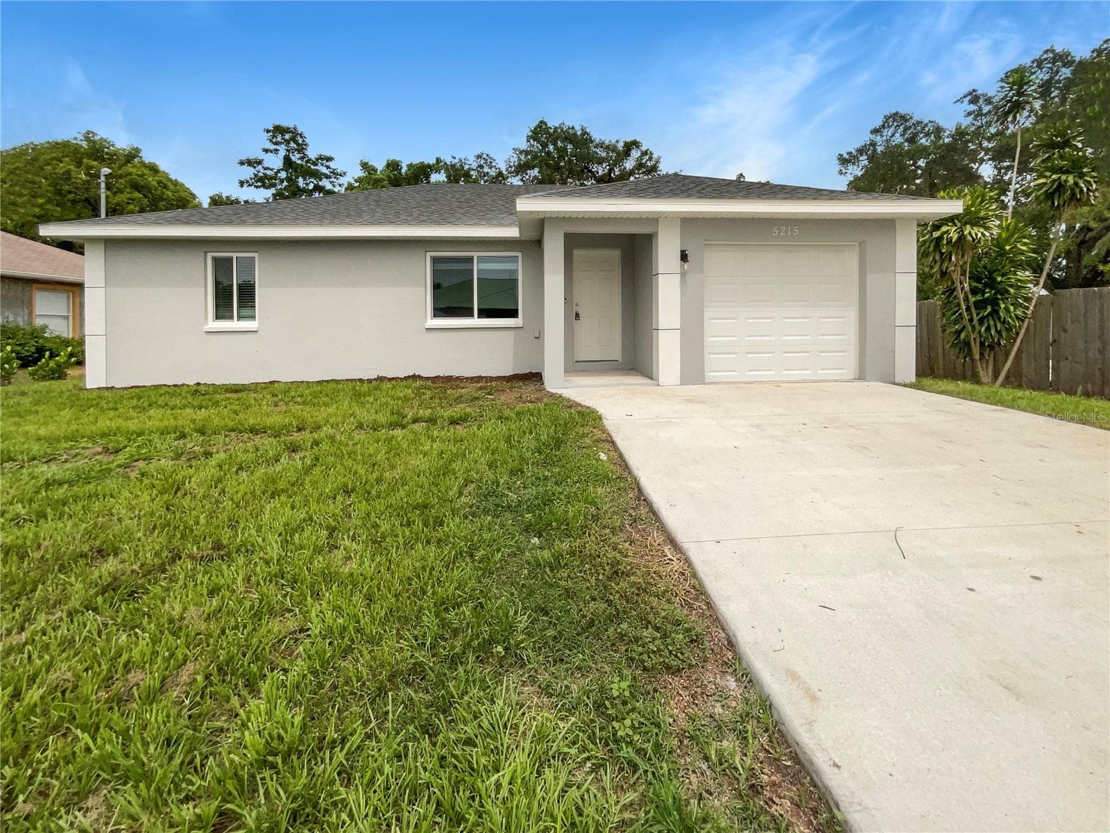 Front exterior of a 2022-built single-family home in Bradenton, Florida with freshly painted facade.