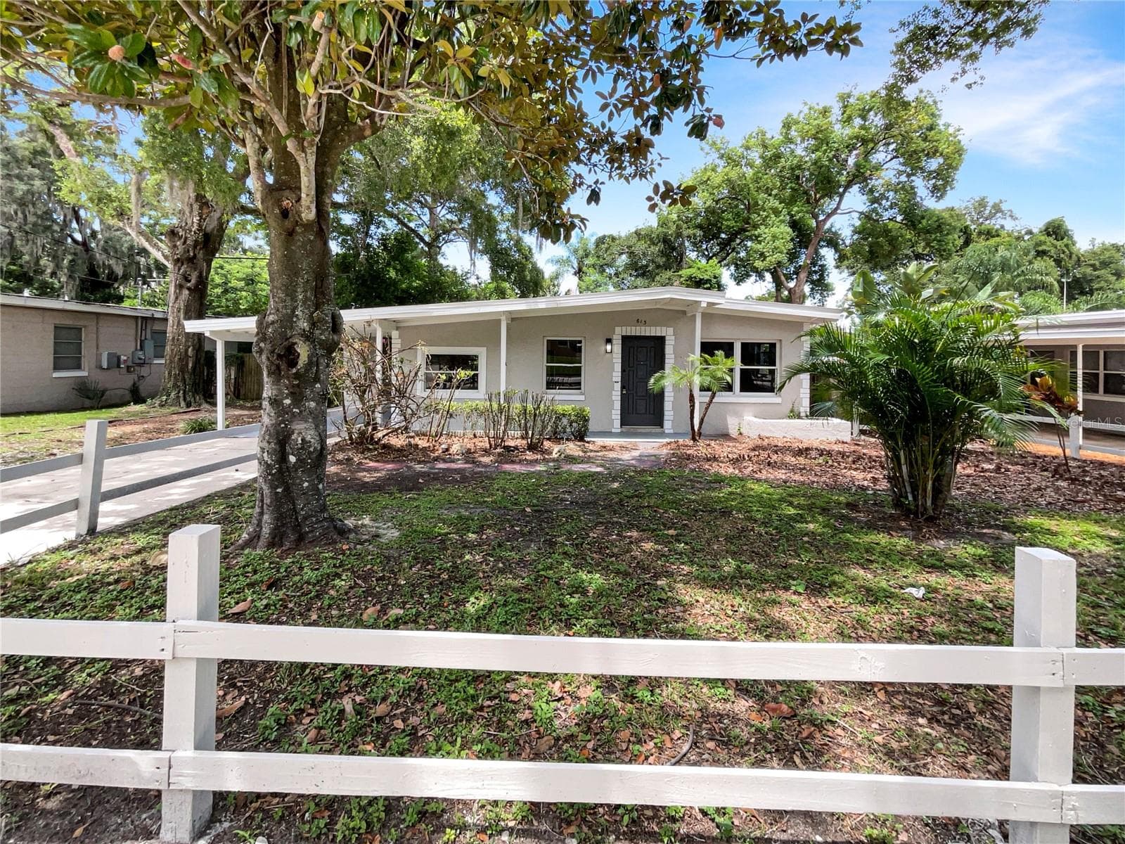 Front exterior of a freshly painted single-family home with updated curb appeal in Altamonte Springs.