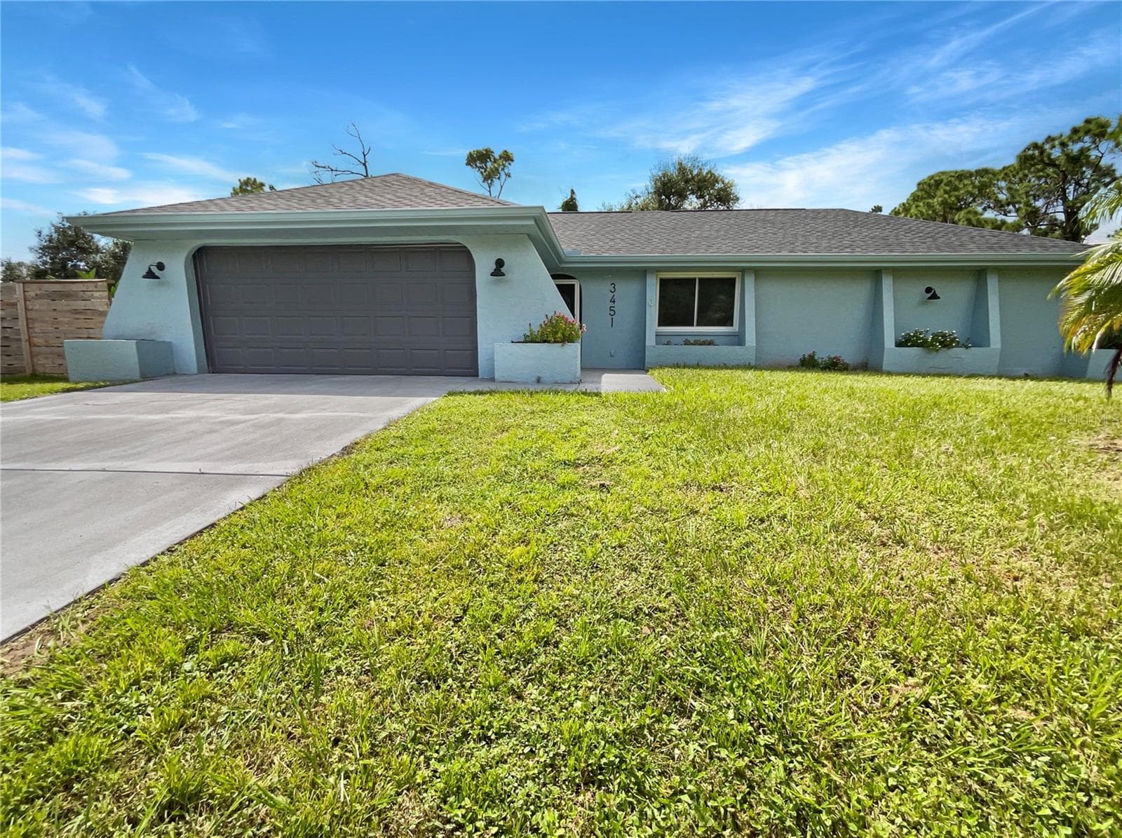 Front exterior of a single-family home on a spacious lot in Port Charlotte, Florida.