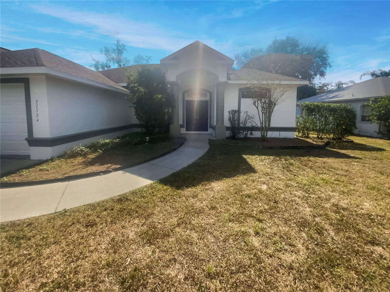 Front exterior of a single-family home with freshly painted facade in Wesley Chapel, FL.