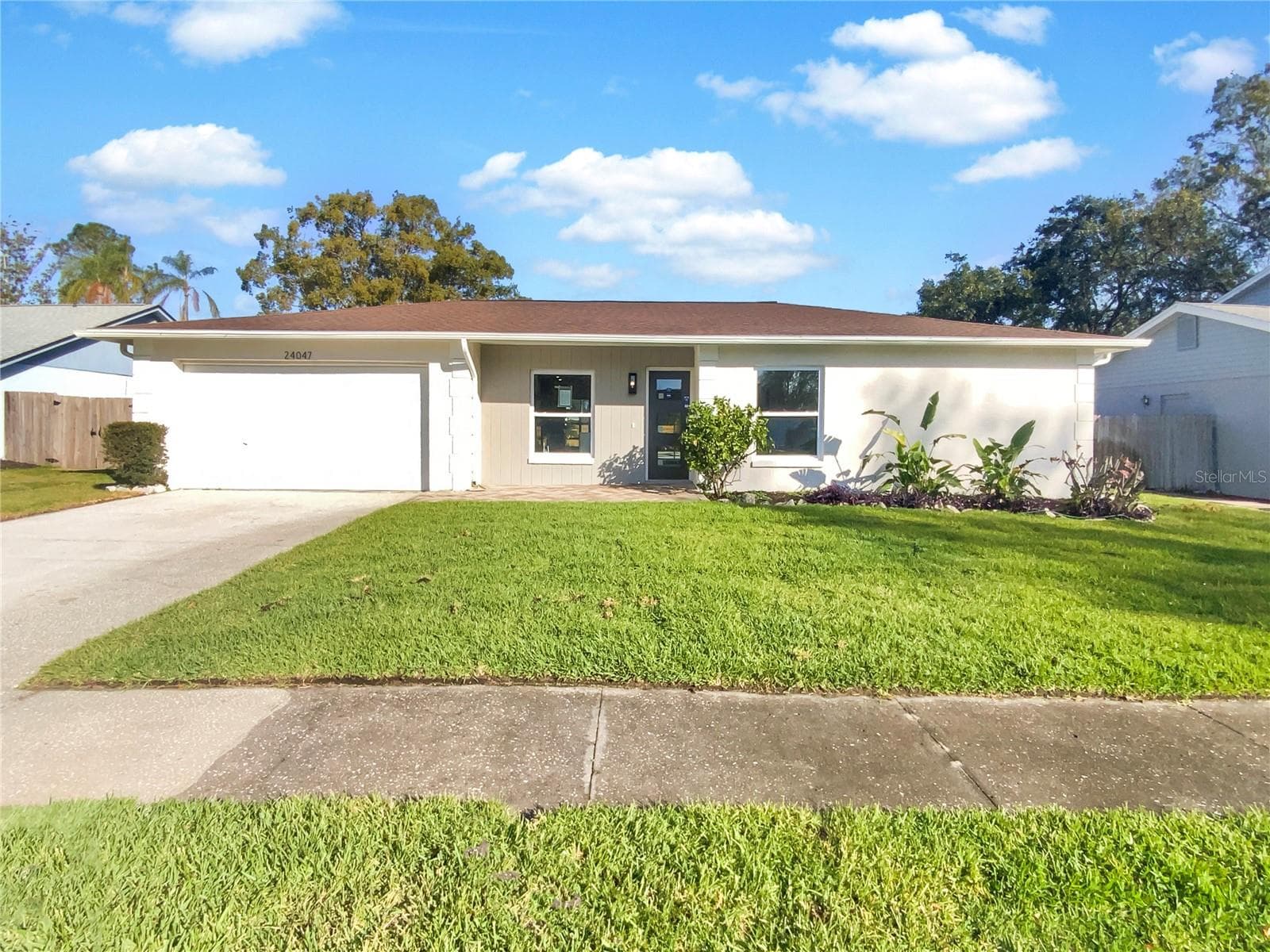 Front exterior of a single-family home with fresh paint in Lutz, Florida.