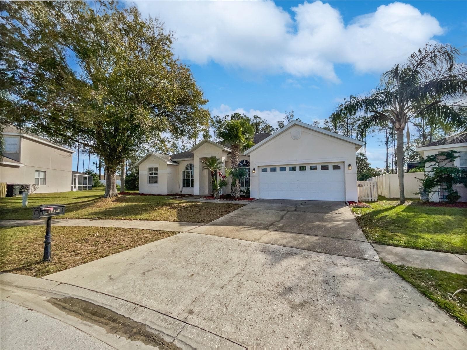 Front exterior of a two-story Florida home with fresh paint and landscaping.