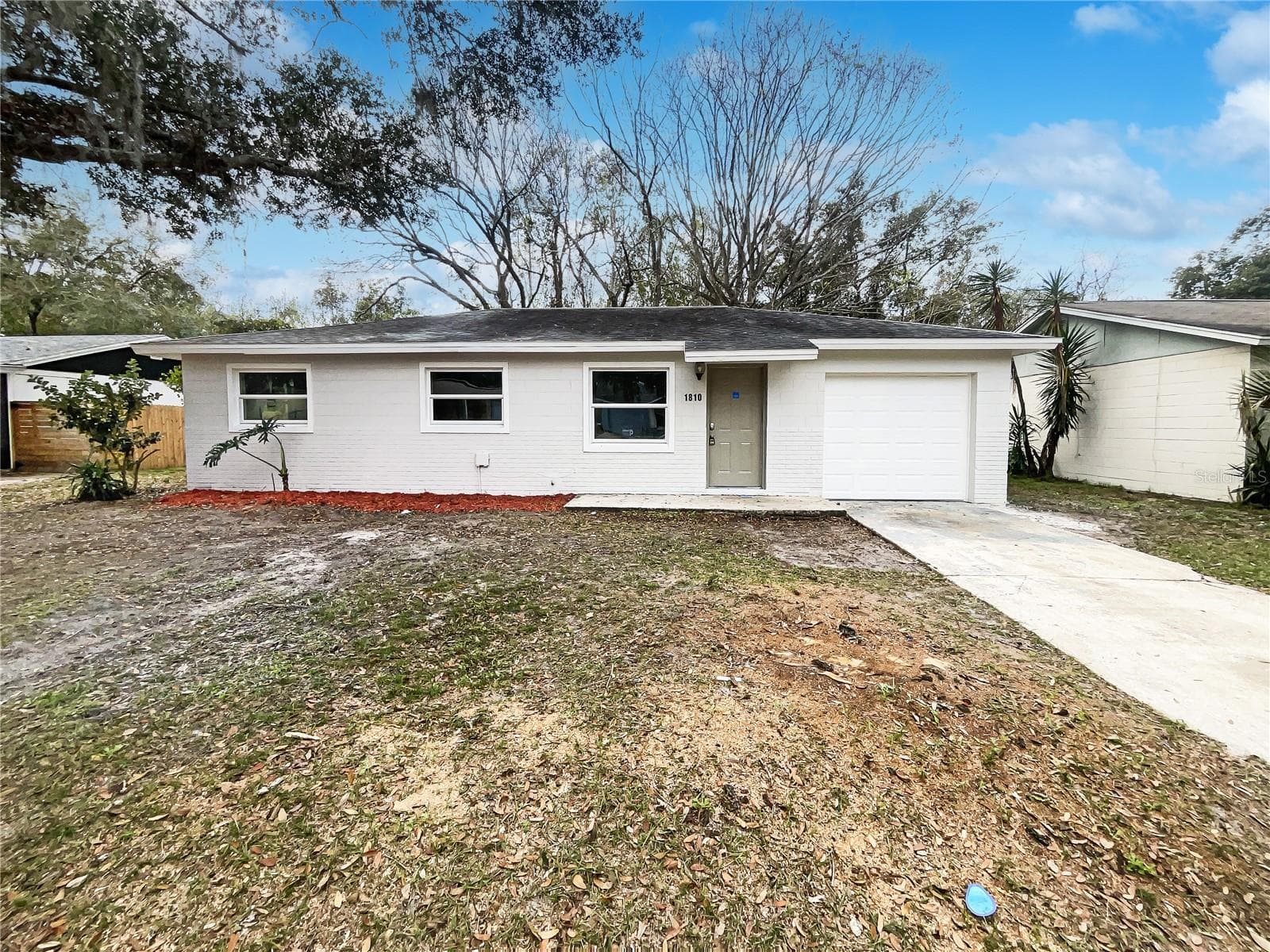 Exterior view of a single-family home with freshly painted facade in Eustis, FL.