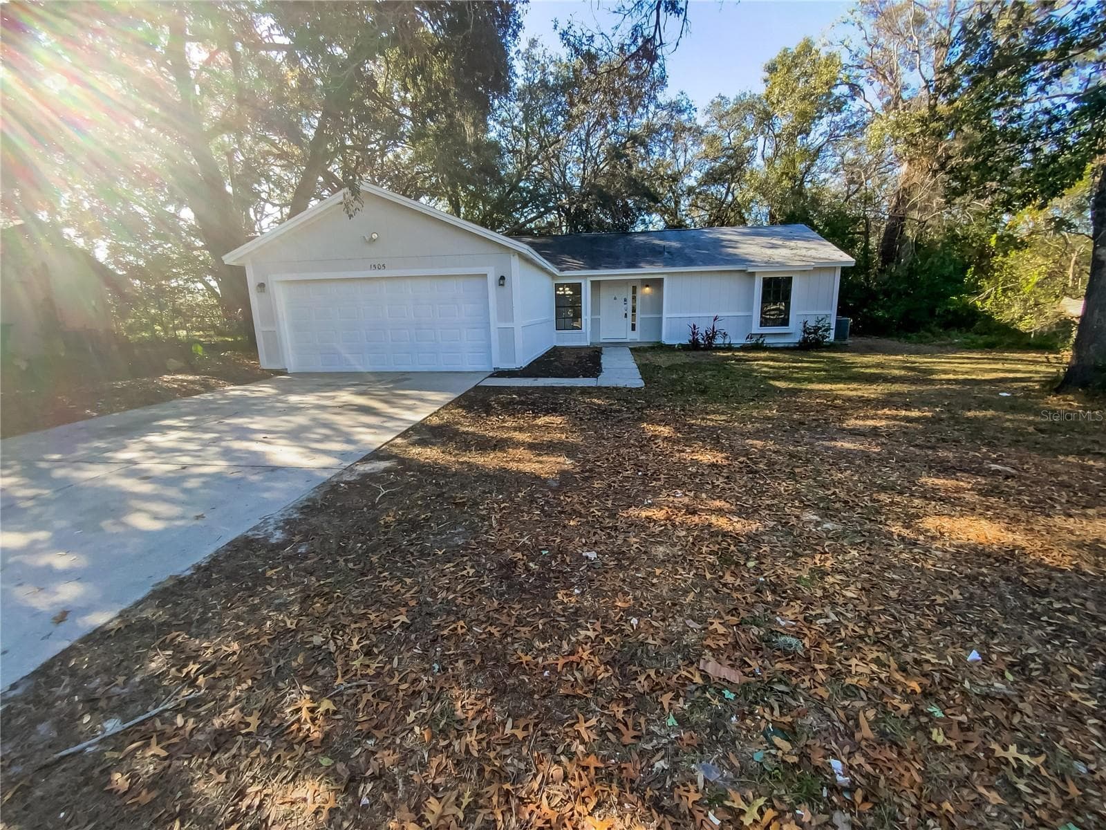Front exterior of a single-family home on a large lot in Spring Hill, FL.