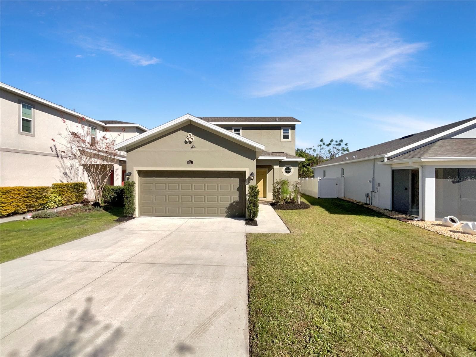 Front exterior of a two-story single-family home in Mirror Lake Village, Fruitland Park