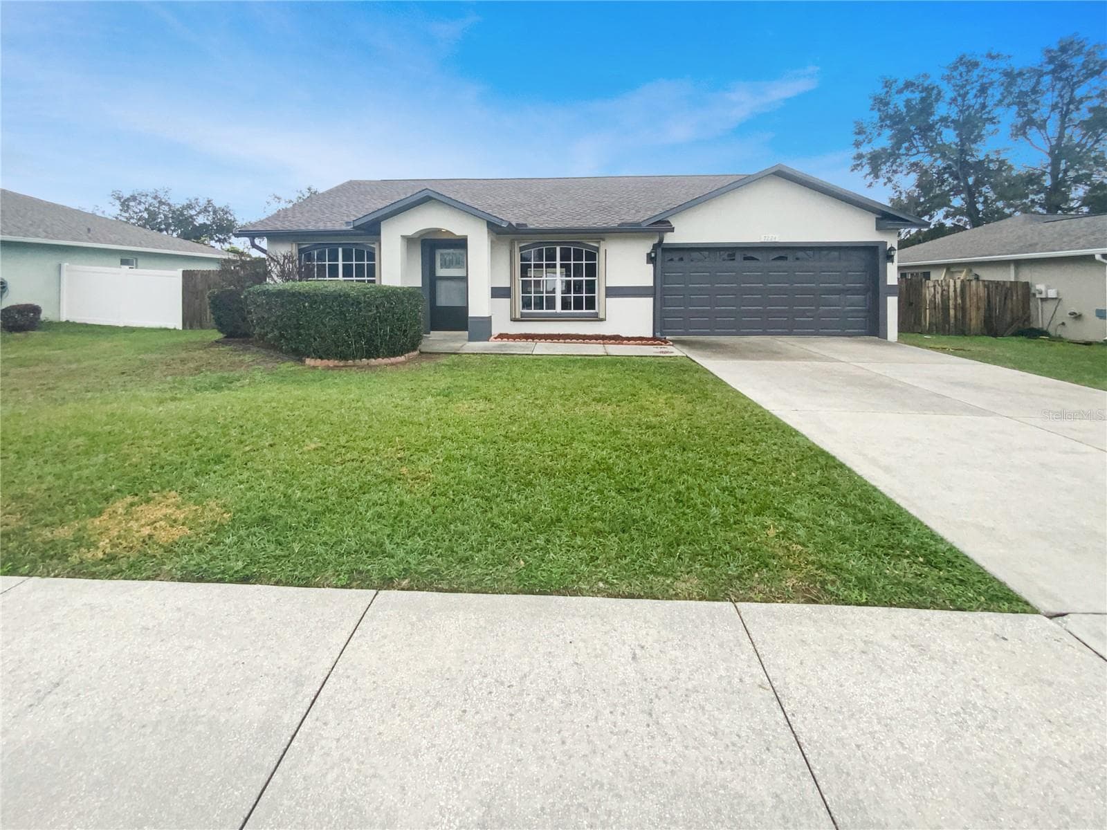 Front exterior view of a single-family home with fresh paint in Zephyrhills Florida