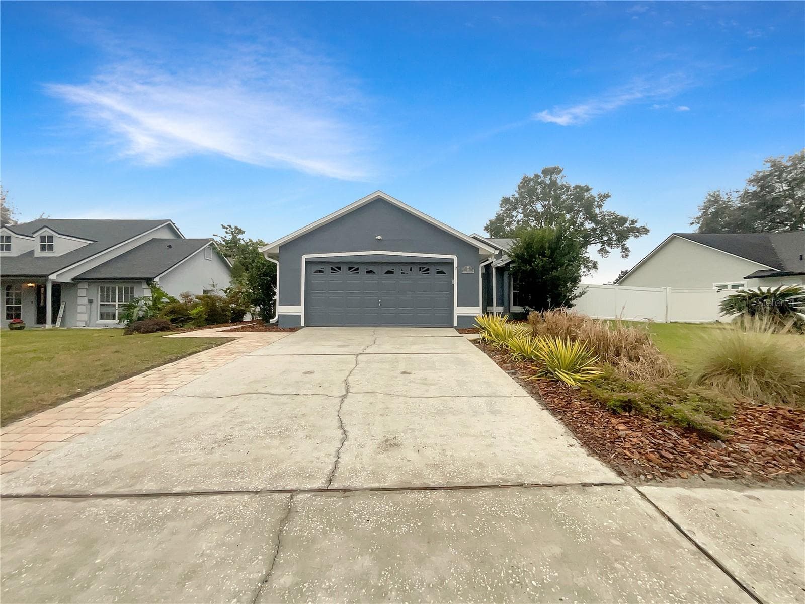 Front exterior of a single-family home in Lake Mary with green lawn and driveway.