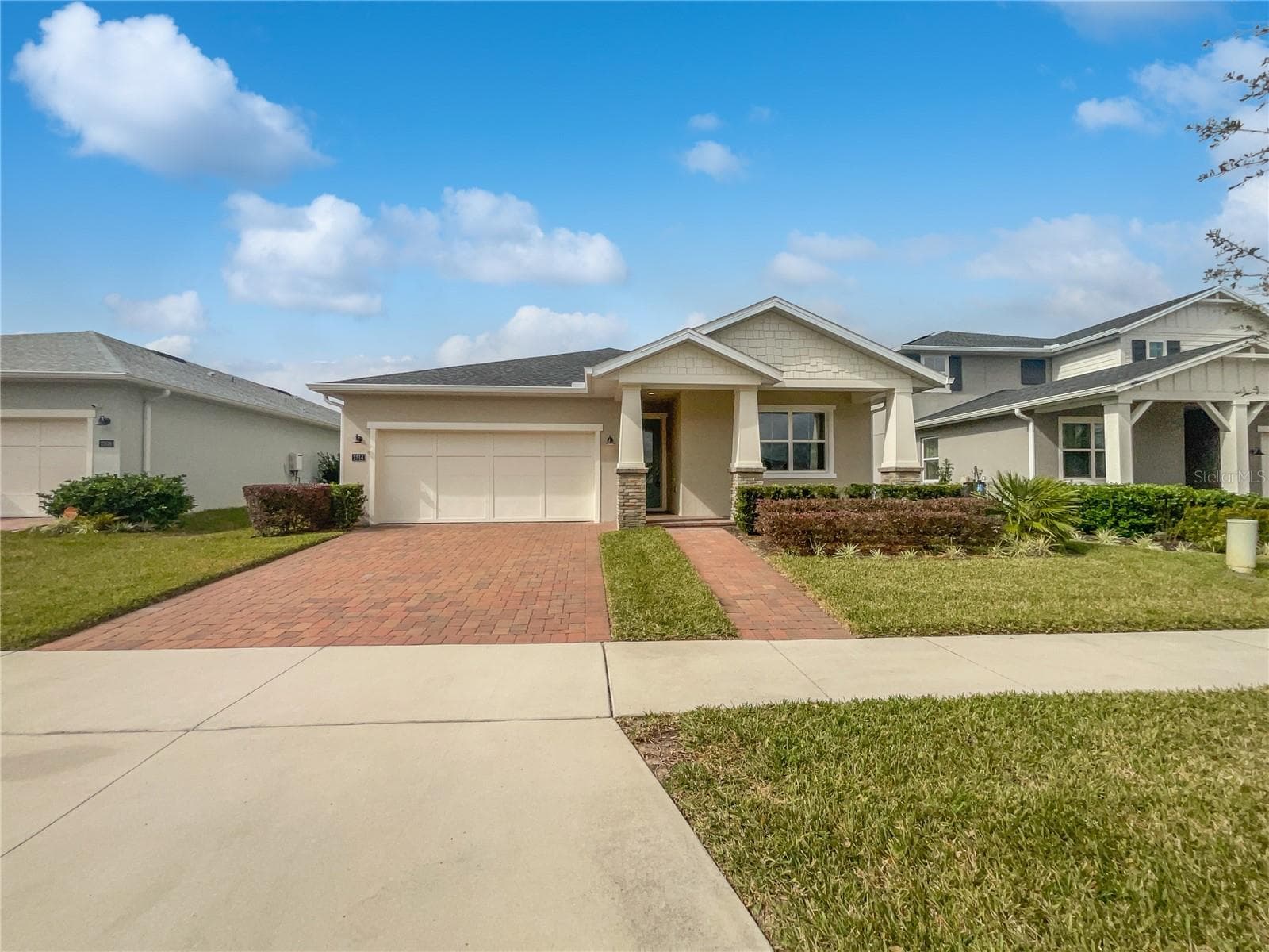 Front exterior of a two-car garage single-family home built in 2021 in Apopka, Florida.