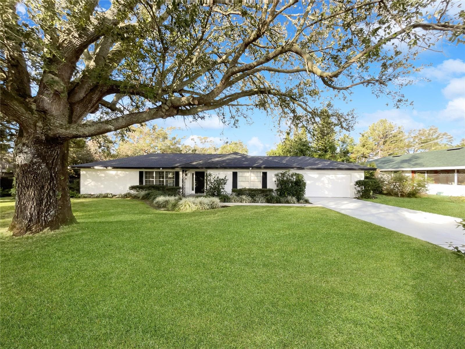 Front exterior of a single-family home with fresh neutral paint in Winter Haven, FL.