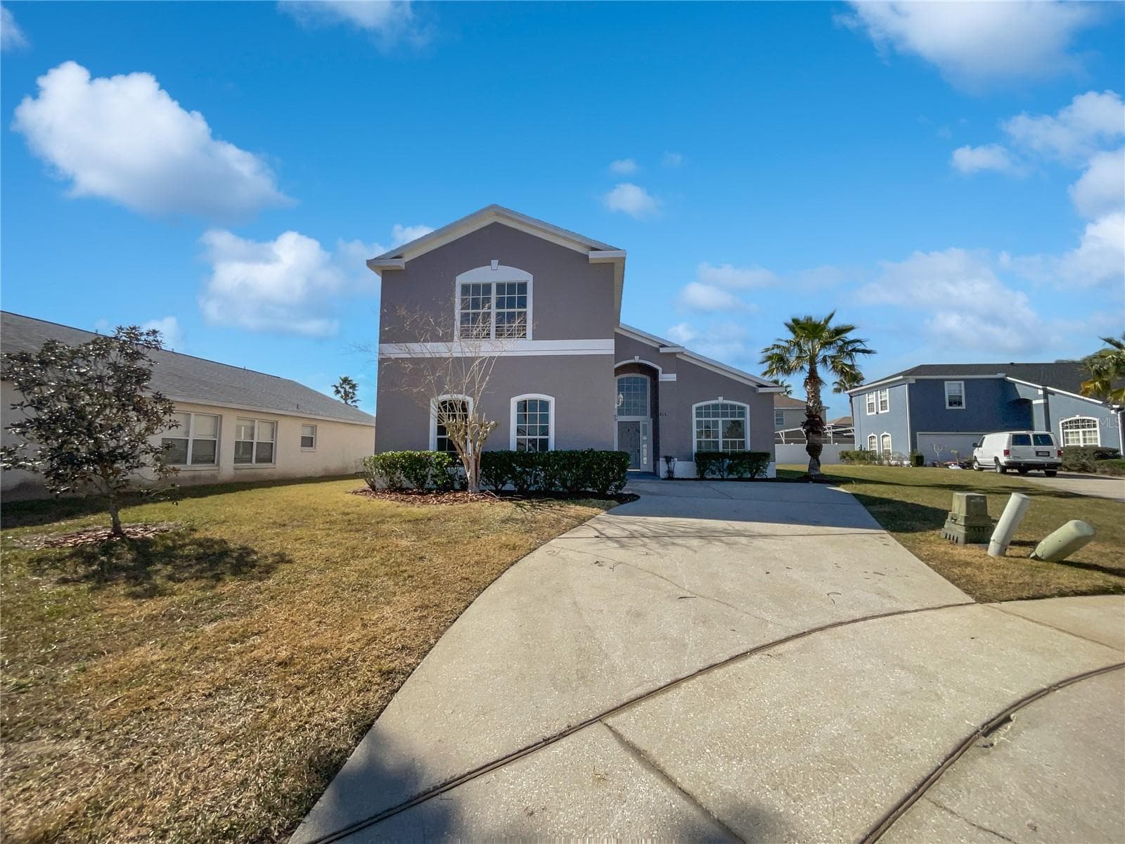 Exterior view of a two-story single-family home with fresh paint in Davenport, FL.