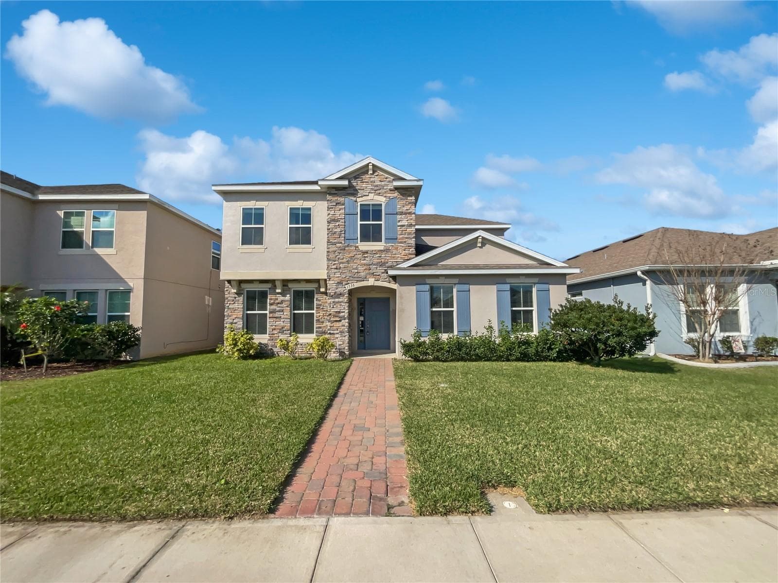 Front exterior of a two-story single-family home in Turtle Creek, St. Cloud, FL