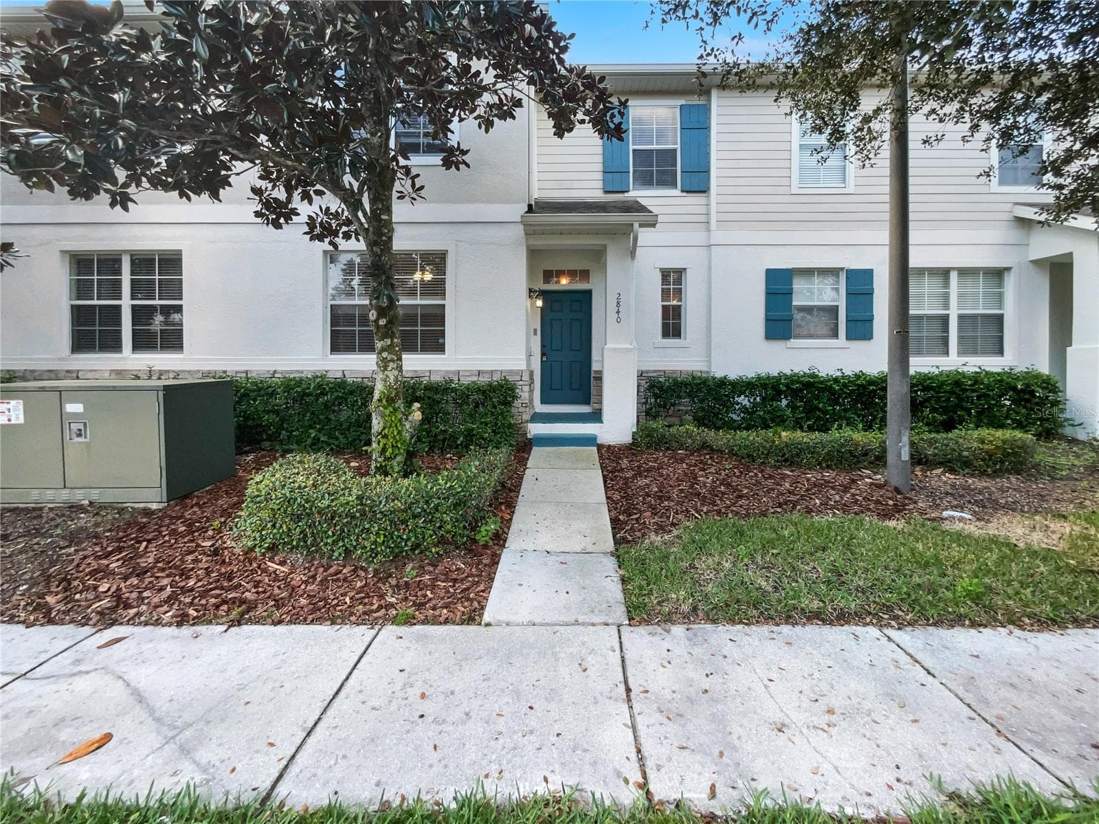 Front exterior view of a two-story townhouse in Concorde Estates, Kissimmee FL