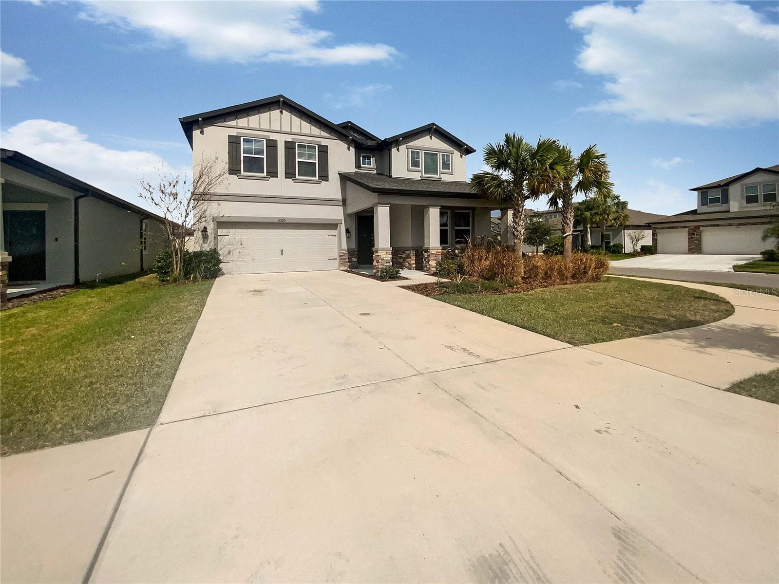 Front exterior view of a two-story single-family home in Wesley Chapel, Florida.