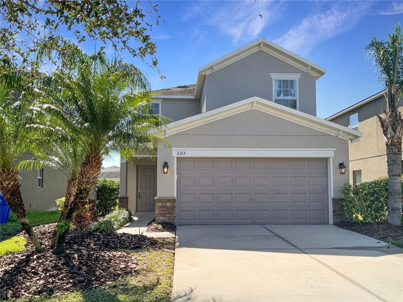 Front exterior of a two-story single-family home with fresh paint in Ruskin FL